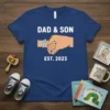 Dad & Son Est. 2023 t-shirt design showing a fist bump between adult and child hands