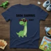 Dada Saurrus Rawr T-Shirt featuring a cartoon dinosaur wearing sunglasses and the text "DADA SAURRUS RAWRI"