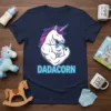 Dadacorn t-shirt design featuring a muscular unicorn hugging a baby unicorn, with the text "DADACORN" below in blue letters