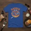 Daddio Of The Patio text design with a grilling theme, featuring a sausage on a fork over a flame-covered grill