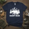 Daddy Bear T-Shirt featuring a white bear with three cubs on its back, set against a mountain and pine tree