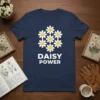Daisy Power t-shirt with a cluster of white daisies and the text "DAISY POWER" in bold white letters
