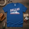 Dallas Skyline T-Shirt featuring the word DALLAS above a white cityscape graphic with red and blue stripes and a star