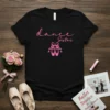 Black t-shirt with pink "dance Sister" text and ballet slippers graphic, featuring a script font and ribbon bow