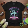 Black t-shirt with "Dancing Like It's 80s With the Coordination of the 2000s" text and a geometric breakdancer graphic