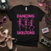 Black t-shirt with "DANCING SKELTONS" in pink, featuring three dancing skeleton graphics
