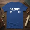 Daniel Master of All T-Shirt with bold white text, lion graphic, and crown shield emblem on a royal blue shirt