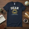 Navy t-shirt with 'DEAN ACADEMIC EXCELLENCE' text and a gold crest featuring an open book, surrounded by laurel leaves