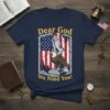 Dear God We Need You! T-Shirt with eagle, praying hands, and distressed American flag graphic