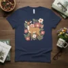 Deer standing among flowers and leaves graphic on a navy blue t-shirt, Deer Floral Design theme