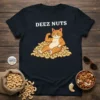 Deez Nuts t-shirt with a cartoon orange cat flexing muscles while sitting on a pile of cashews