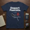 Deport Fascists. quote on a navy blue t-shirt with a graphic of a boot kicking a figure off a cliff