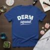 Blue t-shirt with white "DERM squad" text, featuring medical icons like a microscope and magnifying glass