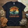 Desert Dominator Scorpion King t-shirt design with a large scorpion graphic and retro sunset