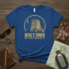 Devil's Tower National Monument text design on a blue t-shirt, featuring a circular graphic of the tower under a moon