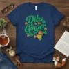 Navy blue t-shirt with green text "Dibs on the Ginger" and a graphic of a girl holding a heart, surrounded