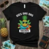 Dies Das Das Ananas t-shirt with a cartoon pineapple wearing sunglasses on a rocket, surrounded by tropical leaves and flowers