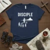Navy blue t-shirt with "DISCIPLE" text and a graphic of a leader with a staff guiding a group of people