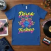 Disco Turkey graphic t-shirt featuring a blue cartoon turkey with colorful disco-inspired peacock feathers and bold yellow and pink text