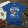 Discovery Shark Week t-shirt design with a leaping shark, sunset, and shark anatomy labels