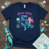 Navy t-shirt with "dive into 5" text, a smiling mermaid, and a jellyfish, designed for a 5th birthday celebration