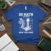 Blue t-shirt with white text "DO MATH NOT MAGIC SHOW YOUR WORK" and math graphics like calculator, abacus, books, and