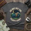 Graphic t-shirt with text "Do Not Pet The Fluffy Cows" above and below a central image of a bison in