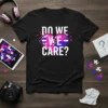 Black t-shirt with "DO WE CARE?" text above a pixelated heart in bisexual flag colors, representing LGBTQ pride