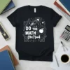 Black t-shirt with white text "DO THE MATH (9x7)+4" featuring a rocket, apple, and rulers, designed for math lovers