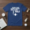 White text "DOES THIS SHIRT MAKE ME LOOK BALD" with comb and head graphic on navy blue t-shirt