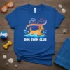 DOG SWIM CLUB text on a blue t-shirt featuring a golden retriever swimming with dolphins overhead