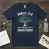 Navy t-shirt with "DONATE LIFE BE AN ORGAN DONOR" text and a heart-shaped tree graphic representing donation awareness