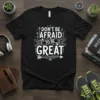 Black t-shirt with white and teal text reading "DON'T BE AFRAID TO BE GREAT" with motivational arrows and design elements