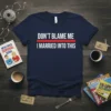 Navy t-shirt with "DON'T BLAME ME I MARRIED INTO THIS" quote in white, separated by a red line. "Don't Blame