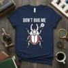 Don't Bug Me t-shirt with a cartoon beetle design and a speech bubble containing an 'X'
