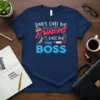 Don't Call Me Princess call me THE BOSS quote with crown, high heel, and lipstick graphics on a navy t-shirt