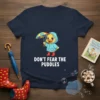 Cute cartoon duck wearing a blue raincoat and red boots, holding an umbrella, with the text "DON'T FEAR THE PUDDLES"