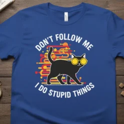 Blue t-shirt with white text "DON'T FOLLOW ME I DO STUPID THINGS" and a graphic of a black cat wearing