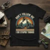 Don't Follow Me I Do Stupid Things motocross quote t-shirt with a rider on a dirt bike jumping over rocks