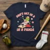 Baseball pickle character wearing a uniform on a t-shirt with text "Don't Get In A Pickle In A Pickle"