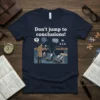 Navy t-shirt with "Don't jump to conclusions!" text and a detective examining a broken bridge graphic