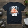 Don't Let The Hard Days Win quote on a navy t-shirt with graphic fists breaking through a wall