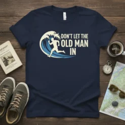 Don't Let The Old Man In quote on a navy t-shirt with a runner graphic overcoming a wave
