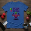 Don't Make Me Throw A Beet Down! text with a muscular cartoon beet character flexing on a blue t-shirt