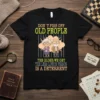 T-shirt with "Don't Piss Off Old People" text and cartoon elderly couple behind bars, stating "The Older We Get The