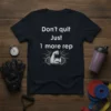 Black t-shirt with white text "Don't quit Just 1 more rep" and graphic of a muscular arm lifting a barbell