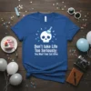 Blue t-shirt with white skull wearing a party hat and blue confetti, text reads "Don't take Life Too Seriously; You