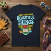 T-shirt with "DON'T TAKE THESE BEAUTIFUL THINGS THAT WE GOT" text and graphics of a book, plant, and gems