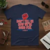 Bold red text "DON'T TELL US HOW WE'RE GONO FEEL" on a navy t-shirt with a red fist graphic and