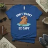 Don't Worry Be Capy t-shirt with a cartoon cowboy capybara in water